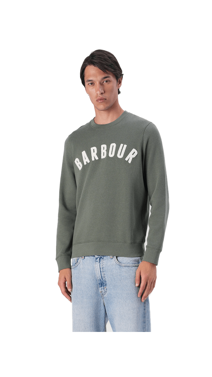 Man wearing Barbour Essential Prep Logo Crew sweatshirt in green, featuring vintage logo design for autumn style.